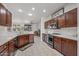 Modern kitchen with dark wood cabinets and white countertops at 16935 W Villagio Dr, Surprise, AZ 85387