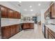 Modern kitchen with dark wood cabinets and white countertops at 16935 W Villagio Dr, Surprise, AZ 85387