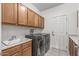 Laundry room with washer, dryer, cabinets, and sink at 16935 W Villagio Dr, Surprise, AZ 85387