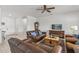 Bright and airy living room with leather sofas, a wood coffee table, and a TV at 16935 W Villagio Dr, Surprise, AZ 85387