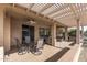 Covered patio with table and chairs, perfect for outdoor dining at 16935 W Villagio Dr, Surprise, AZ 85387