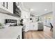 Modern kitchen with white cabinets, quartz countertops, and stainless steel appliances at 1744 W Encinas St, Gilbert, AZ 85233