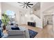 Bright living room featuring hardwood floors, a ceiling fan, and comfortable seating at 1744 W Encinas St, Gilbert, AZ 85233