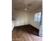 Bedroom with wood-look flooring, a ceiling fan, and a window at 18202 N Cave Creek Rd # 108, Phoenix, AZ 85032