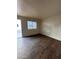 Living room with wood-look flooring, neutral walls, and a sliding door at 18202 N Cave Creek Rd # 108, Phoenix, AZ 85032