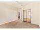 Bedroom with mirrored closet doors and access to bathroom at 18970 N Alicante St, Maricopa, AZ 85138