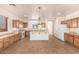 Kitchen features island, light wood cabinets, and tile floors at 18970 N Alicante St, Maricopa, AZ 85138