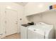 Laundry room with washer, dryer, and storage shelves at 18970 N Alicante St, Maricopa, AZ 85138