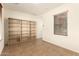 Home office with built-in shelving and tile floors at 18970 N Alicante St, Maricopa, AZ 85138