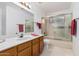 Bathroom with tub, shower, and wood vanity at 19662 N 93Rd Dr, Peoria, AZ 85382