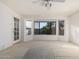 Bright bedroom featuring a window and French doors at 19662 N 93Rd Dr, Peoria, AZ 85382