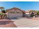 Two-car garage with desert landscaping and driveway at 19662 N 93Rd Dr, Peoria, AZ 85382