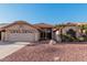 Single-story home with a two-car garage and desert landscaping at 19662 N 93Rd Dr, Peoria, AZ 85382