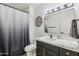 Clean bathroom with dark vanity and a large mirror at 19777 N 76Th St # 2263, Scottsdale, AZ 85255