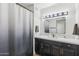 Modern bathroom with dark vanity and a large mirror at 19777 N 76Th St # 2263, Scottsdale, AZ 85255