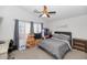 Bedroom with a queen-size bed, a ceiling fan, and an attached desk at 20234 N 71St Ln, Glendale, AZ 85308