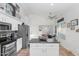 Modern kitchen with white cabinets, stainless steel appliances, and an island at 20234 N 71St Ln, Glendale, AZ 85308