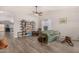 Bright living room with wood-look floors, green couch, and built-in shelving at 20838 N 101St Dr, Peoria, AZ 85382