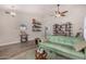 Living room with green couch, wood-look floors, and a ceiling fan at 20838 N 101St Dr, Peoria, AZ 85382