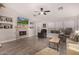 Living room with fireplace, hardwood floors, and large TV at 20838 N 101St Dr, Peoria, AZ 85382