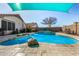 Refreshing blue pool with large rocks and shade sail at 20838 N 101St Dr, Peoria, AZ 85382