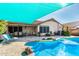 Inviting backyard pool with patio and shade sail at 20838 N 101St Dr, Peoria, AZ 85382