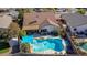 Aerial view of a relaxing backyard featuring a sparkling pool, patio, and shed at 20838 N 101St Dr, Peoria, AZ 85382