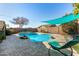 Inviting backyard pool with patio and shade structure at 20838 N 101St Dr, Peoria, AZ 85382