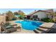 Relaxing kidney-shaped pool, surrounded by patio at 20838 N 101St Dr, Peoria, AZ 85382