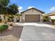 Tan house with a brown garage door and gravel landscaping at 21816 N 261St Ave, Buckeye, AZ 85396