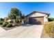 House exterior with a brown garage door and well-maintained landscaping at 21816 N 261St Ave, Buckeye, AZ 85396