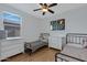 Bright bedroom with two twin beds, dresser, and window at 22085 E Rosa Rd, Queen Creek, AZ 85142