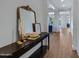 Elegant entryway with console table, mirror, and hardwood floors at 22085 E Rosa Rd, Queen Creek, AZ 85142