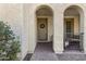 Front entrance with arched entryway, and small patio with seating area at 22085 E Rosa Rd, Queen Creek, AZ 85142