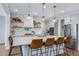 Bright kitchen with an island, white cabinets, and modern pendant lights at 22085 E Rosa Rd, Queen Creek, AZ 85142