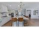 Modern kitchen with white cabinets, large island, and stainless steel appliances at 22085 E Rosa Rd, Queen Creek, AZ 85142