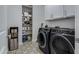 Laundry room with washer, dryer, and storage shelves at 22085 E Rosa Rd, Queen Creek, AZ 85142