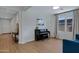 Living room with piano, hardwood floors, and teal couch at 22085 E Rosa Rd, Queen Creek, AZ 85142