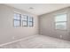 Bright bedroom with neutral carpeting and multiple windows at 23472 S 210Th St, Queen Creek, AZ 85142