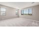 Spacious bedroom with neutral walls and carpet flooring and large windows at 23472 S 210Th St, Queen Creek, AZ 85142