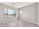 Bright bedroom with large window and wood-look floors at 23472 S 210Th St, Queen Creek, AZ 85142