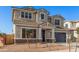 Two-story house with a gray exterior, blue garage door, and landscaping at 23472 S 210Th St, Queen Creek, AZ 85142