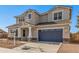 Two-story house with a gray exterior, blue garage door, and landscaping at 23472 S 210Th St, Queen Creek, AZ 85142