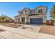 Two-story house with a gray exterior, blue garage door, and landscaping at 23472 S 210Th St, Queen Creek, AZ 85142