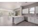 Modern kitchen with white cabinets, quartz countertops, and stainless steel appliances at 23472 S 210Th St, Queen Creek, AZ 85142