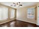 Bright bedroom with dark laminate flooring and window coverings at 23618 W Adams St, Buckeye, AZ 85396