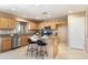 Kitchen with light wood cabinets, granite counters, and island at 23618 W Adams St, Buckeye, AZ 85396