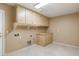 Bright laundry room with built-in cabinets and tile flooring at 23618 W Adams St, Buckeye, AZ 85396