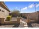 Landscaped side yard with gravel pathway and rock border at 23618 W Adams St, Buckeye, AZ 85396