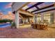 Large covered patio featuring a dining area, lounge seating and pool access at 27931 N Montana Dr, Rio Verde, AZ 85263